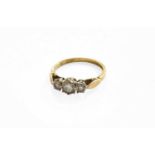 An 18 Carat Gold Diamond Three Stone Ring, the graduated round brilliant cut diamonds in white