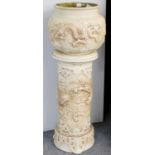 A Bretby Jardiniere and Stand, early 20th century, ivory ground and moulded in relief with