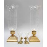Halcyon Days, a pair of gilt metal and glass specimen vases, each surmounted by a putti and on