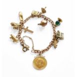 A Curb Link Bracelet, suspending eleven charms including a 1914 half sovereign, a typewriter, a
