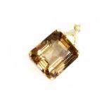 A Smoky Quartz Pendant, the emerald cut smoky quartz in a yellow four claw setting, to a textured