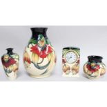 Modern Moorcroft Pottery, three vases and a mantel timepiece in the Anna Lily pattern by Rachel