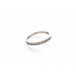 A Diamond Half Hoop Ring, twelve round brilliant cut diamonds, in a white channel setting, to a