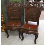 A pair of early 20th century Oriental carved hall chairs, (2)