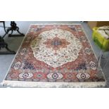 An Indian Rug, the ivory field of vines centred by a terracotta medallion, framed by spandrels and