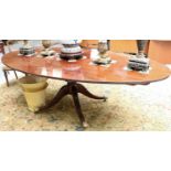 A Regency Style Mahogany Oval Dining Table, on pillar supports, 229cm by 122cm by 73cm Subject to