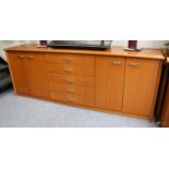 Neudorfler: A Cherrywood Sideboard, with five central drawers flanked by four cupboard doors201cm by