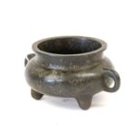 A Chinese Bronze Censer, of cushioned form with loop handle, on three feet, incised and gilt with