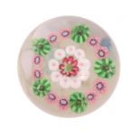 A Clichy Miniature Concentric Paperweight, circa 1850, the central red and white florette within a
