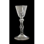 A Newcastle Light Baluster Wine Glass, circa 1740, the rounded funnel bowl on a ball knop with air