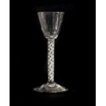 A Wine Glass, circa 1750, the rounded funnel bowl on a mixed twist stem15cm highSome bubble