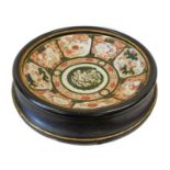 A Japanese Kutani Charger, Meiji period, painted with underglaze green panels containing flowers and