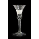 A Wine Glass, circa 1740, the thistle shaped bowl, with basal air tear on an incised twist stem17.