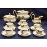 A Paris Porcelain Part Tea Service, circa 1820, with wide gilt borders and enamelled with pastoral