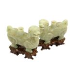 A Pair of Jade-Type Figural Incense Burners, in Archaic style, as standing lion dogs15cm long, on