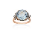 An Aquamarine and Diamond Ringthe round cut aquamarine in yellow claw settings, flanked by eight-cut