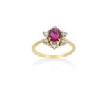 An 18 Carat Gold Ruby and Diamond Cluster Ringthe round cut ruby within a border of round