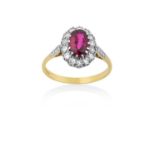 An 18 Carat Gold Synthetic Ruby and Diamond Cluster Ringthe oval cut synthetic ruby within a