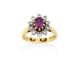 An 18 Carat Gold Ruby and Diamond Cluster Ringthe oval cut ruby in a yellow claw setting, within a