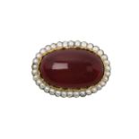 A Garnet and Split Pearl Broochthe oval carbuncle garnet within a border of split pearls, in