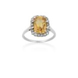 A Yellow Sapphire and Diamond Cluster Ringthe rectangular cushion cut yellow sapphire within a