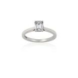 A Platinum Diamond Solitaire Ringthe emerald-cut diamond in a four claw setting, to a tapered