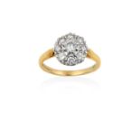 An 18 Carat Gold Diamond Cluster Ringthe central raised round brilliant cut diamond within a