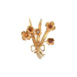 A 9 Carat Gold Multi-Gem Set Brooch realistically modelled as ribbon tied flowers, the round cut
