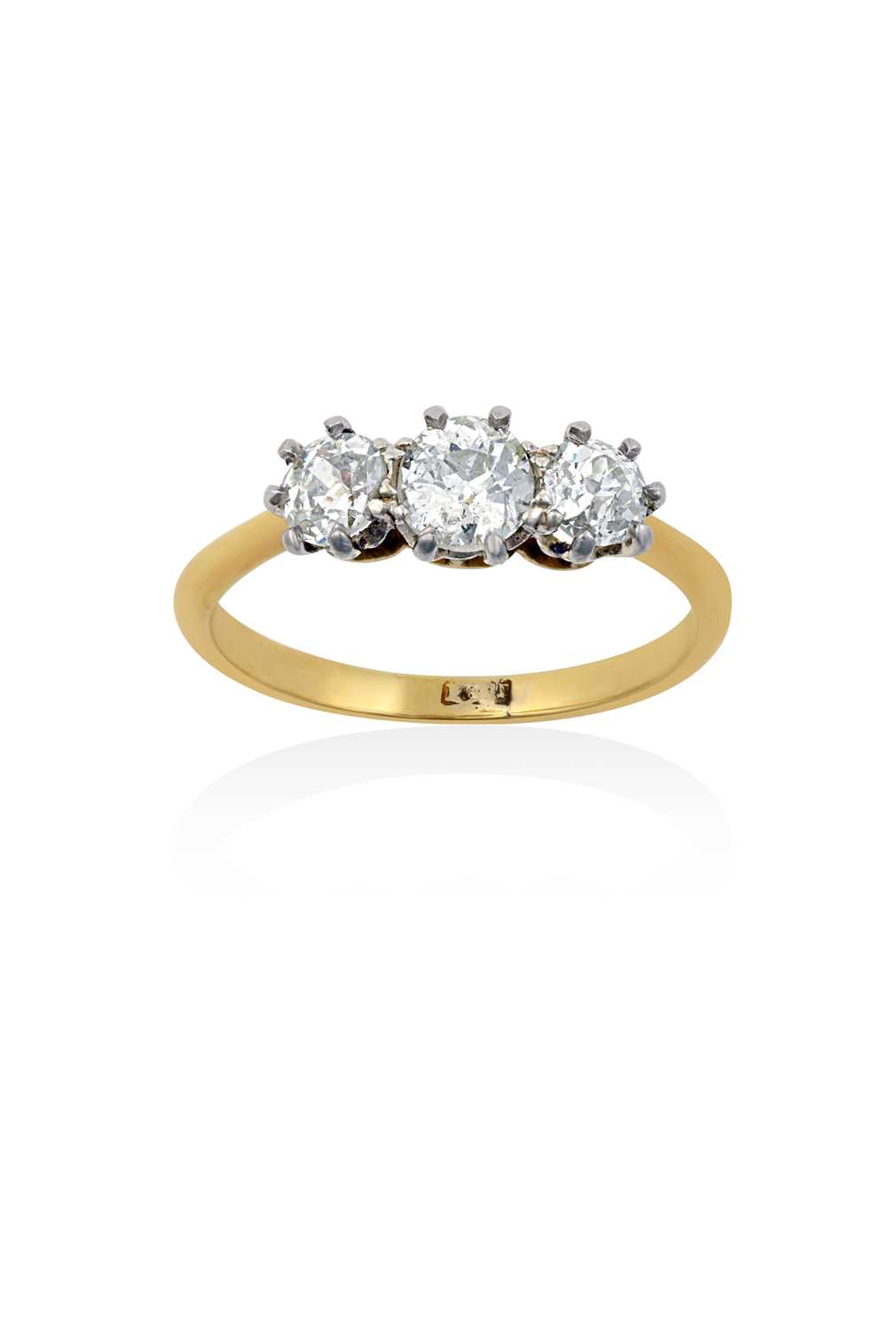 A Diamond Three Stone Ringthe graduated old cut diamonds in white claw settings, to a yellow tapered