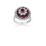 A Ruby and Diamond Cluster Ringthe central raised ruby within a triple stepped border of round