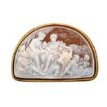 A Cameo Broochthe demi lune shell cameo depicts a mythical scene, in a yellow rubbed over setting,