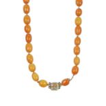 An Amber Bead Necklacethe thirty-seven amber beads knotted to an emerald-cut rock crystal clasp,