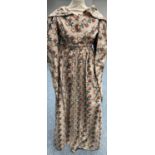 Circa 1830s Cotton Dress, printed with floral motifs on a primarily brown ground, wide collar,