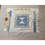 Circa 1930s Patchwork Quilt, comprising frames of decorative vibrant cottons around a central square