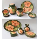 A Collection of Moorcroft Pottery, coral hibiscus on green grounds, including ginger jar and