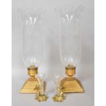 Halcyon Days, a pair of gilt metal and glass specimen vases, each surmounted by a putti and on