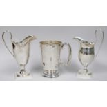 A George V Silver Mug and Two Cream-Jugs, the mug by Walker and Hall, Sheffield, 1934, tapering