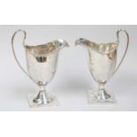 Two George III Silver Cream-Jugs, by Peter and Ann Bateman, London, 1796, each helmet-shaped and