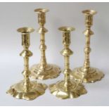 A Pair of 18th century Brass Ejector Candlesticks; with petal bases; together with a similar pair (