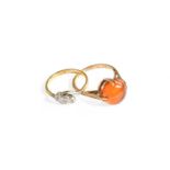 A Diamond Three Stone Twist Ring, stamped '18CT&PLAT', finger size N; and An Amber Ring, stamped '