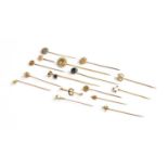 Fifteen Stickpins, including enamel examples, diamond examples, split pearl examples, a moonstone