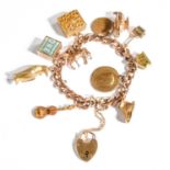A Charm Bracelet, stamped '9' and '.375', hung with eleven charms including a penguin, a horse, a
