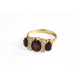 An 18 Carat Gold Garnet and Diamond Ring, finger size LGross weight 4.6 grams.