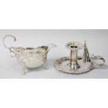 A George III Silver Sauceboat and an Edward VII Silver Chamber-Candlestick, the first by Abraham