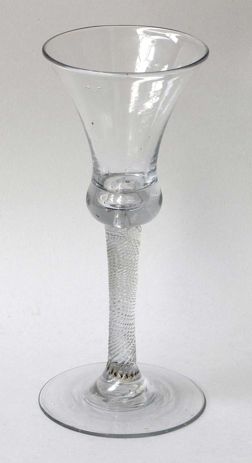 A Wine Glass, circa 1740, the thistle shaped bowl, with basal air tear on an incised twist stem17.