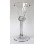 A Wine Glass, circa 1740, the thistle shaped bowl, with basal air tear on an incised twist stem17.