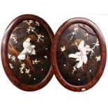 A Pair of Japanese Bone and Mother of Pearl Oval Panels, decorated in high relief with vines,