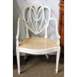 A 19th Century Heart Shaped Shield Back Open Arm Chair, later painted white with floral and