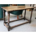An 18th Century Carved Oak Side Table, 117cm by 51cm by 71cmSome cracks forming to the top. Mild