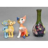 A Moorcroft Clematis Pattern Bottle Vase, together with a Goebel cat designed by R. Wachtmeister and